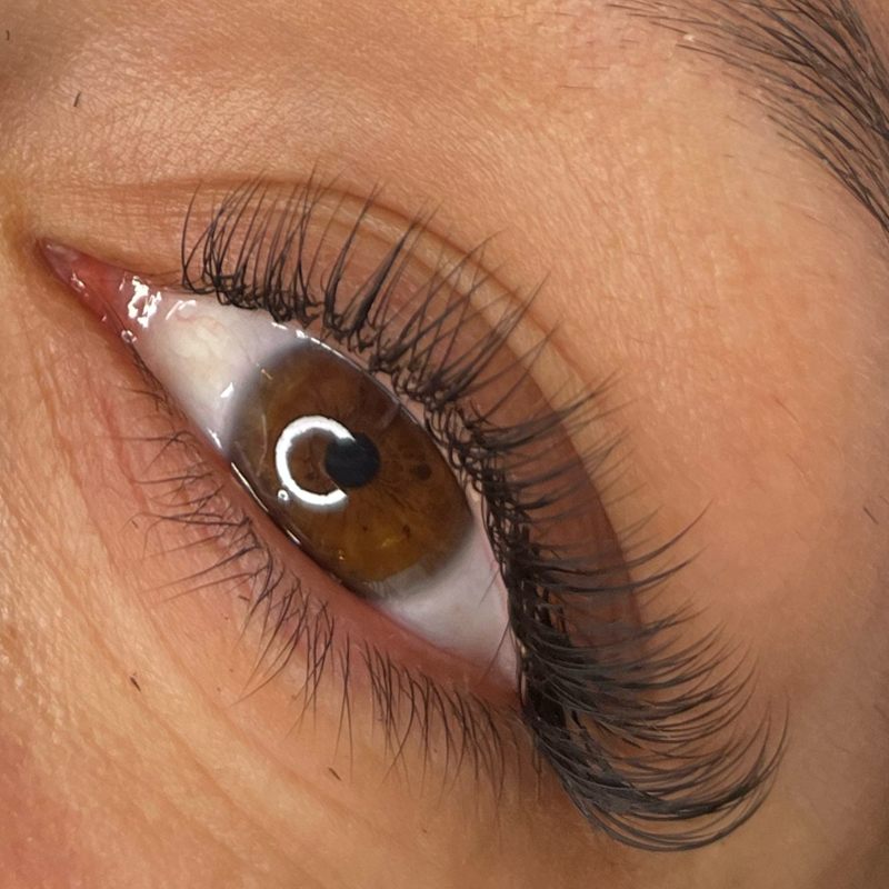 Close up of a soft wispy lash extension set on a brown eye